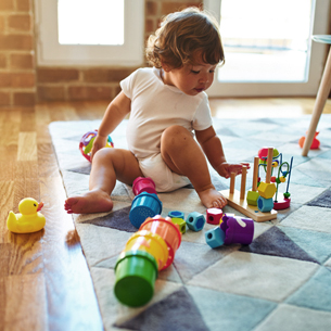 child plays with toys on the ground.jpg